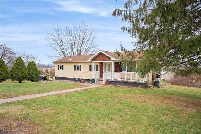 view of front of home with cooling unit, a front lawn, and a porch