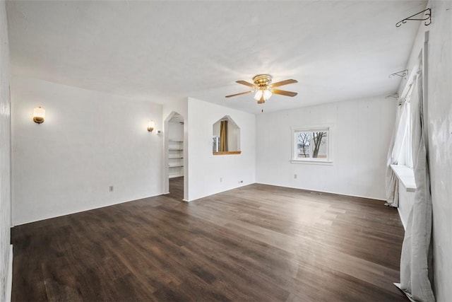 unfurnished living room featuring ceiling fan and dark hardwood / wood-style flooring