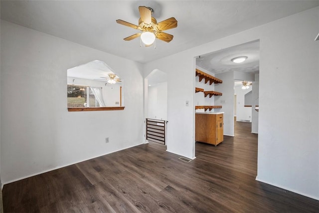 unfurnished living room featuring ceiling fan and dark hardwood / wood-style floors