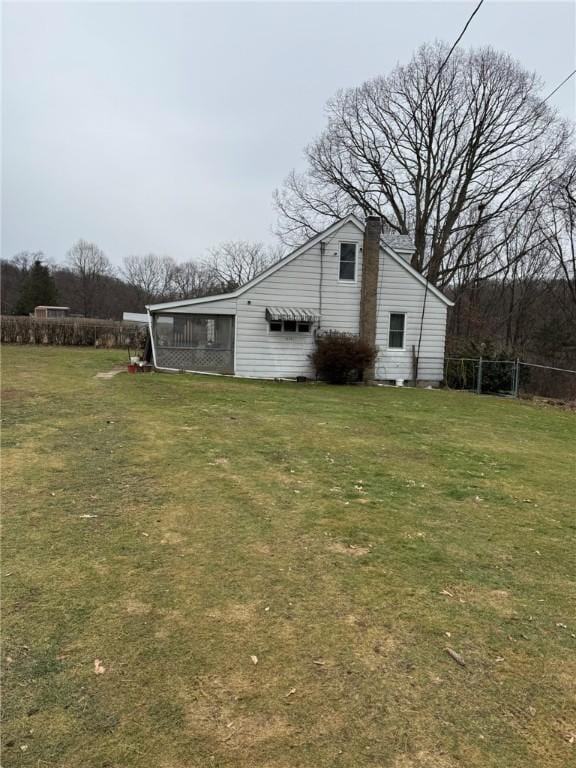 view of side of home featuring a yard