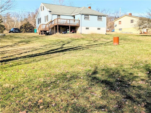 back of house featuring a wooden deck and a lawn