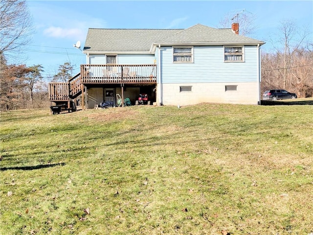 rear view of property with a yard and a deck