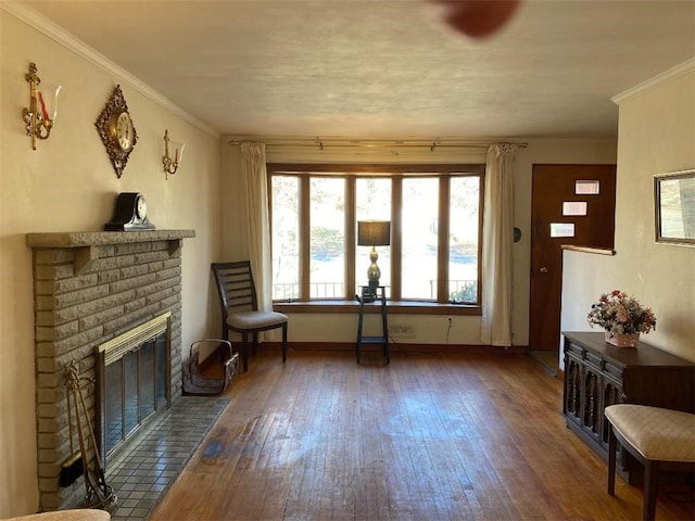 living area with dark wood-type flooring, crown molding, and a brick fireplace