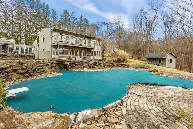 view of pool with an outbuilding