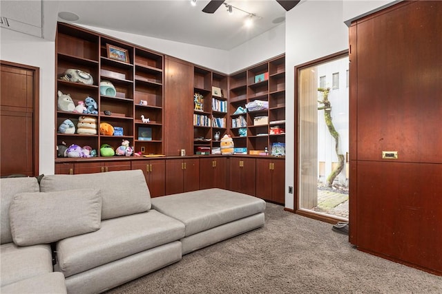 sitting room featuring track lighting, ceiling fan, and carpet