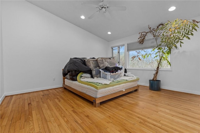 bedroom featuring lofted ceiling, light hardwood / wood-style flooring, and ceiling fan