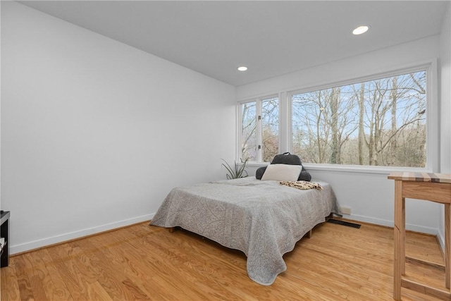 bedroom featuring multiple windows and light hardwood / wood-style floors