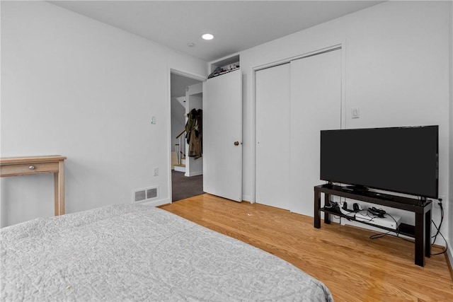 bedroom with hardwood / wood-style flooring and a closet