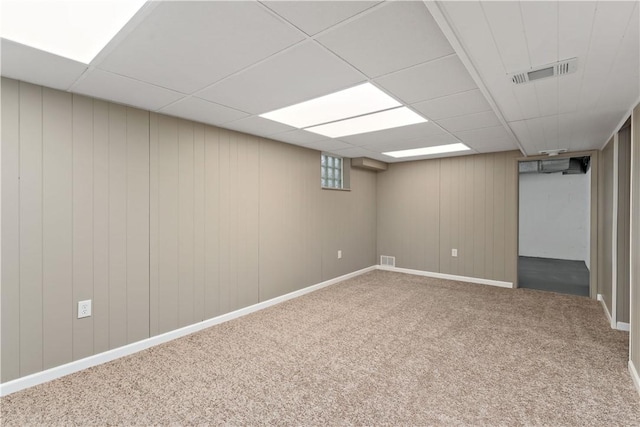 basement featuring carpet floors and a drop ceiling