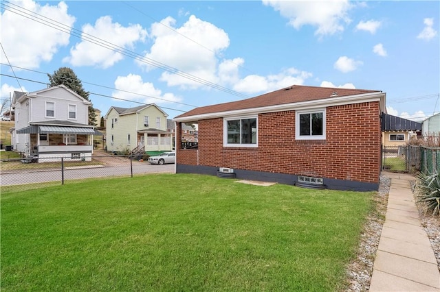 view of side of home featuring a yard