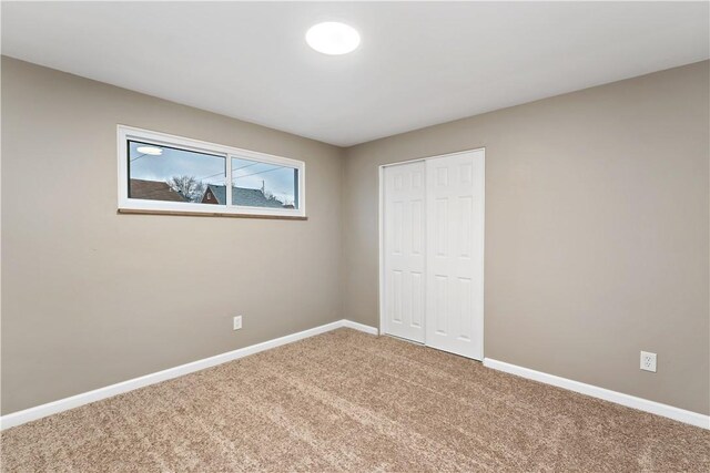 unfurnished bedroom with carpet and a closet