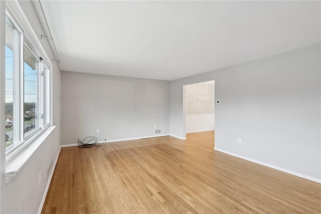 spare room featuring light wood-type flooring