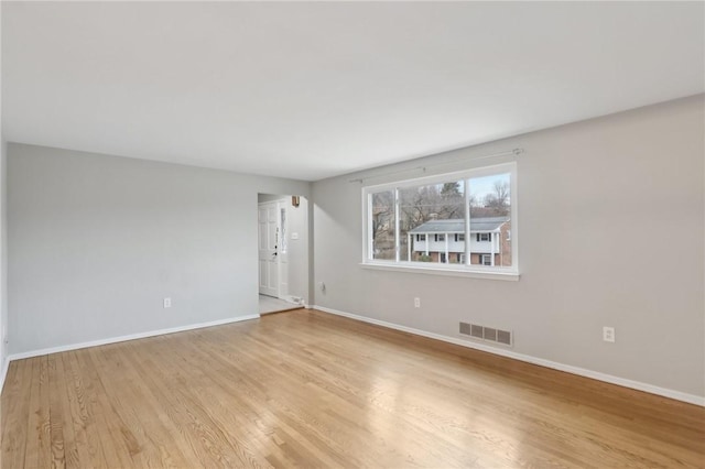 empty room with light hardwood / wood-style floors