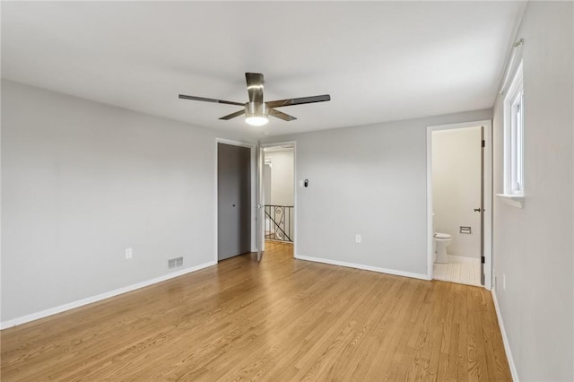 unfurnished room with ceiling fan and light wood-type flooring