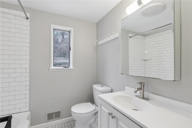 full bathroom featuring tile patterned floors, vanity, toilet, and tiled shower / bath combo