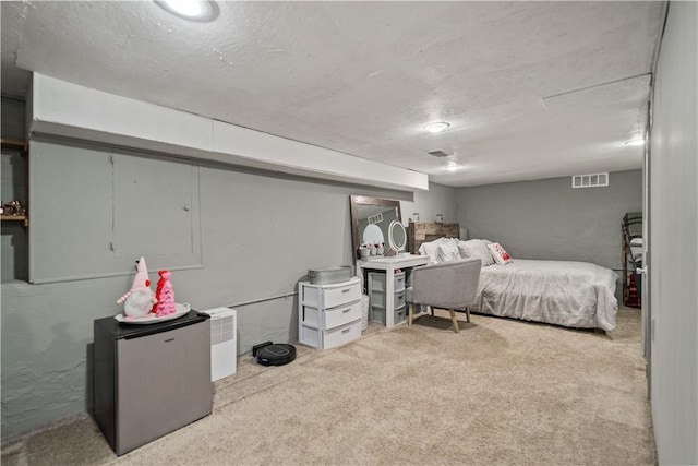 carpeted bedroom featuring stainless steel fridge and a textured ceiling