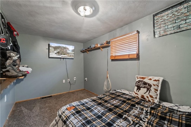 bedroom featuring a textured ceiling and carpet flooring