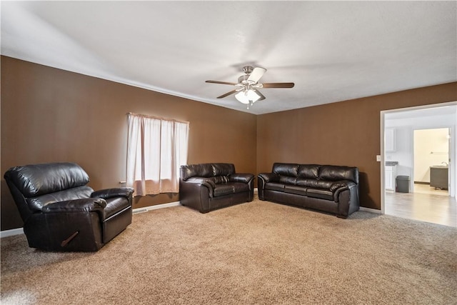 living room featuring light carpet and ceiling fan