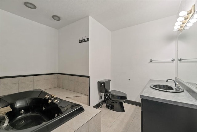 bathroom featuring tile patterned flooring, vanity, tiled bath, and toilet