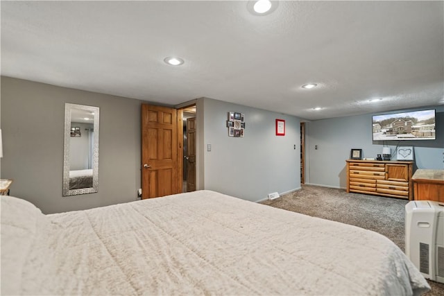 carpeted bedroom with a textured ceiling