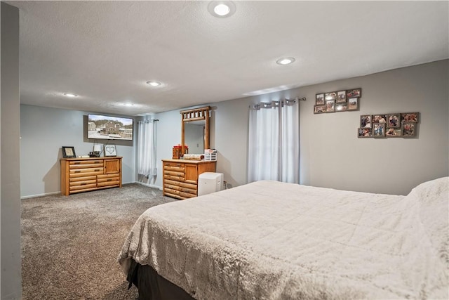 bedroom featuring carpet and a textured ceiling