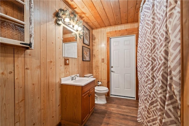 bathroom with toilet, wood ceiling, vanity, wooden walls, and hardwood / wood-style flooring