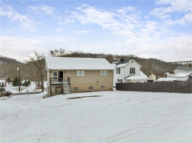 view of snow covered rear of property