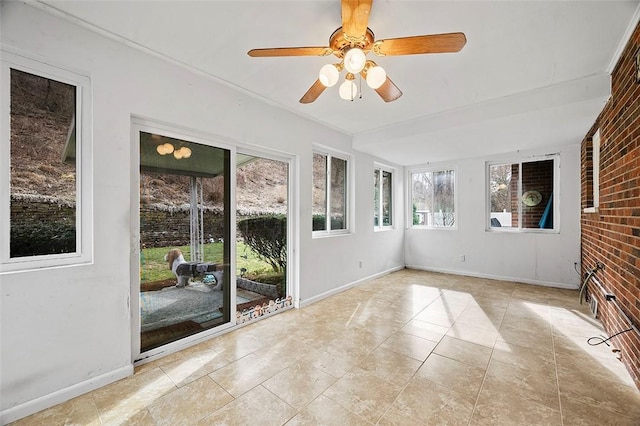 unfurnished sunroom with ceiling fan