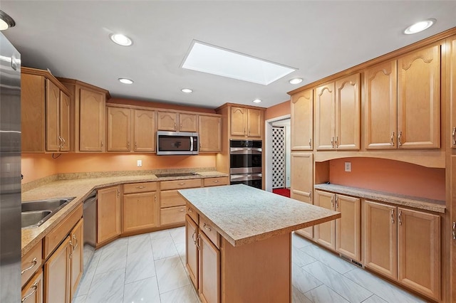 kitchen featuring sink, a skylight, stainless steel appliances, and a center island