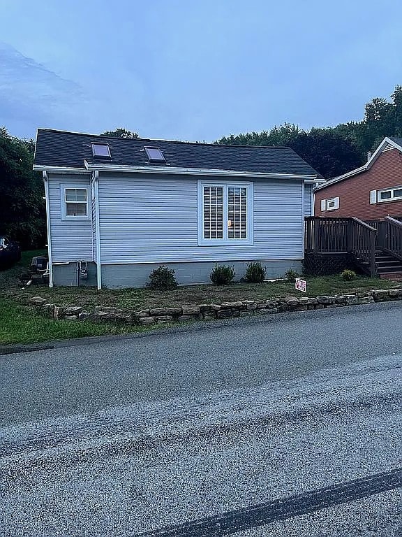 view of home's exterior with a wooden deck