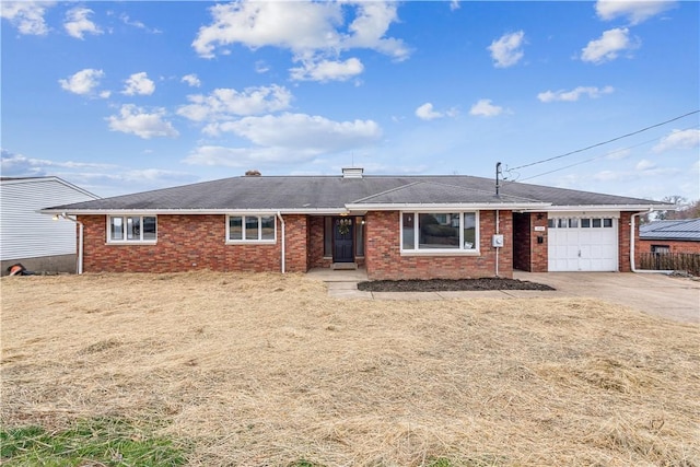 ranch-style house featuring a garage, concrete driveway, and brick siding