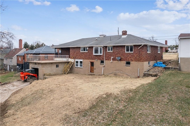 rear view of property featuring a lawn