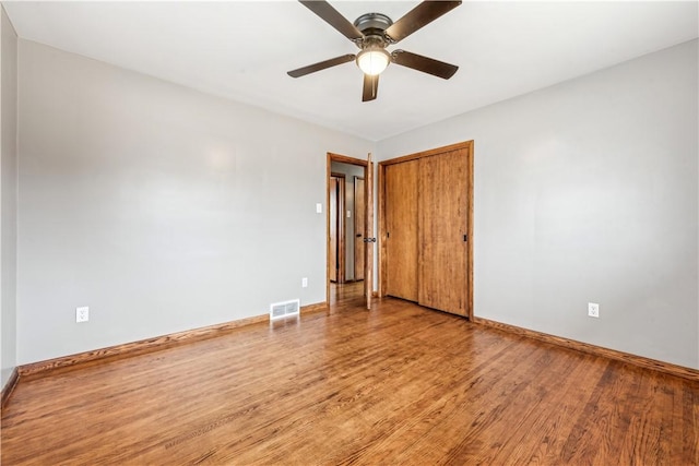 spare room with ceiling fan and wood-type flooring