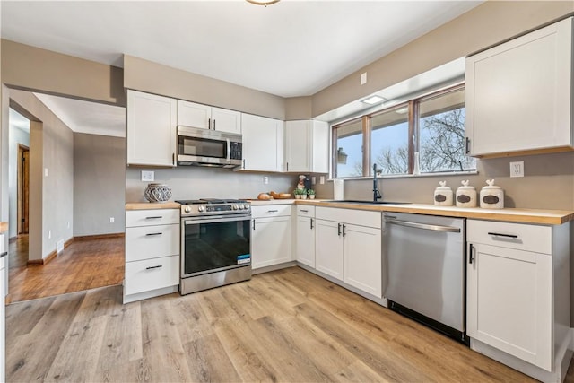 kitchen featuring stainless steel appliances and white cabinets