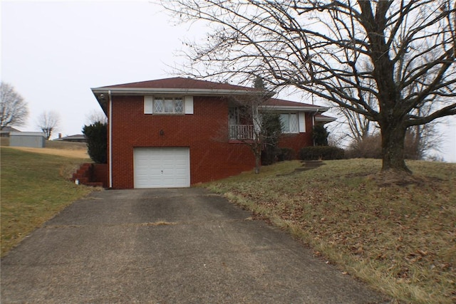 view of front of property with a garage and a front lawn