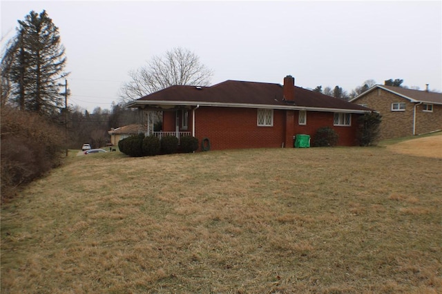 view of side of home with a lawn