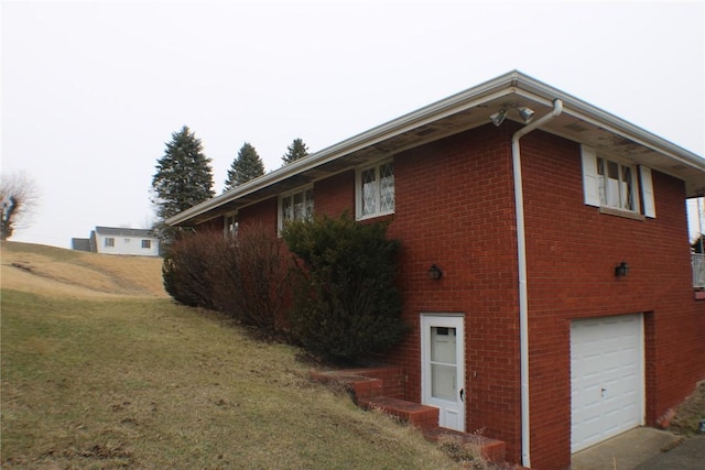 view of side of home with a garage and a lawn