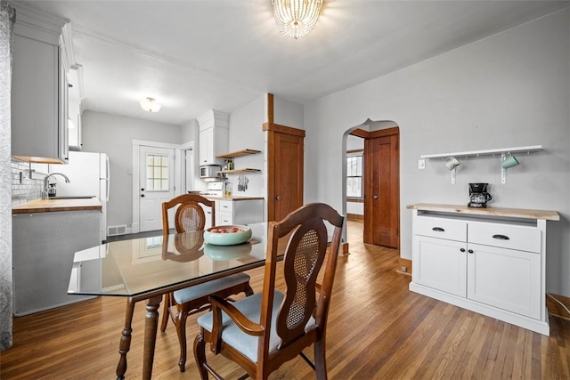 dining room with dark hardwood / wood-style floors and sink