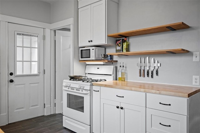 kitchen featuring white cabinetry, white appliances, and wood counters