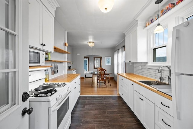 kitchen featuring butcher block counters, sink, white appliances, and white cabinets