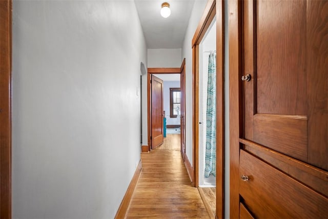 corridor with light hardwood / wood-style floors