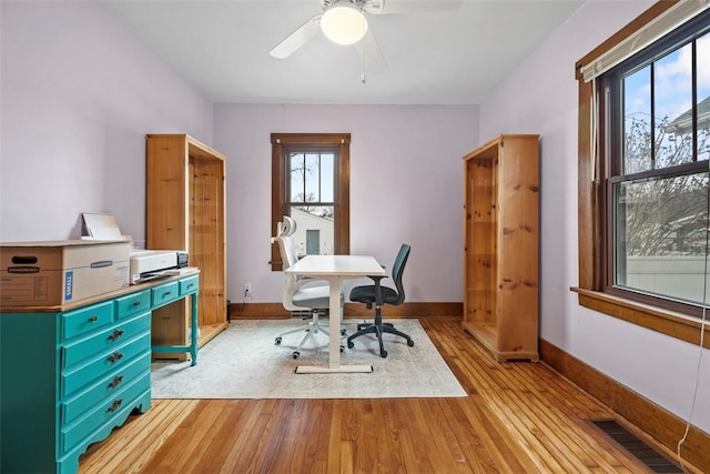 office space featuring ceiling fan and light hardwood / wood-style flooring