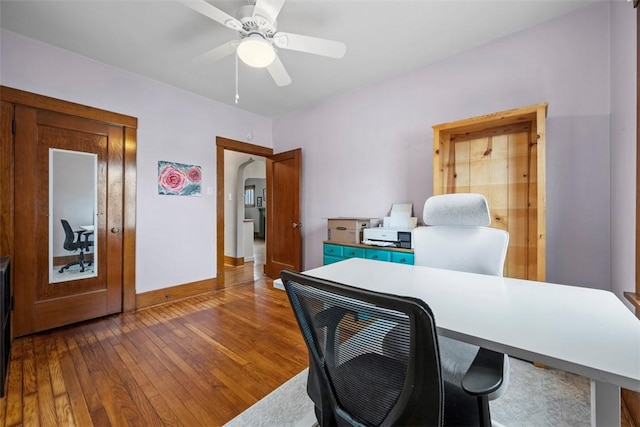 office featuring dark wood-type flooring and ceiling fan