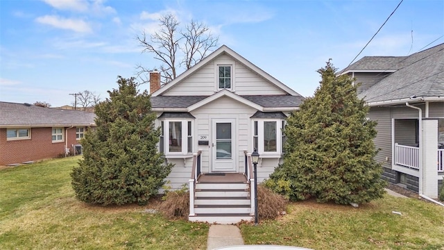 bungalow-style home featuring a front yard