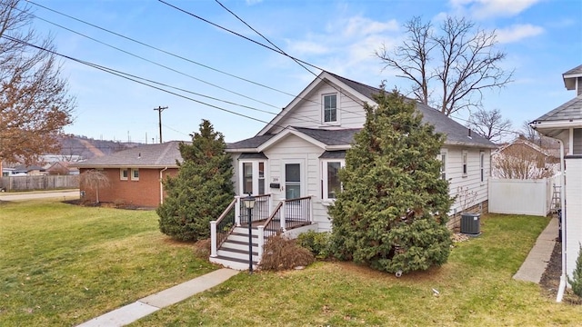 bungalow-style house with central AC and a front lawn