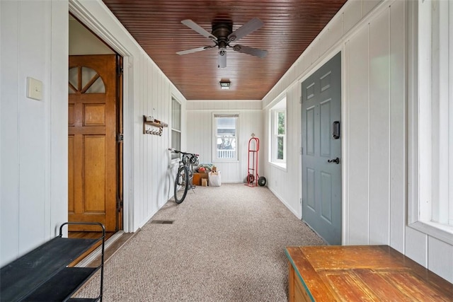 sunroom with wood ceiling and ceiling fan