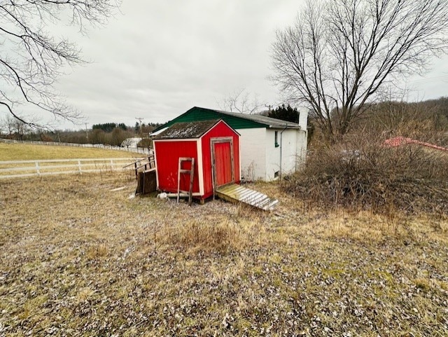 view of outbuilding featuring a rural view