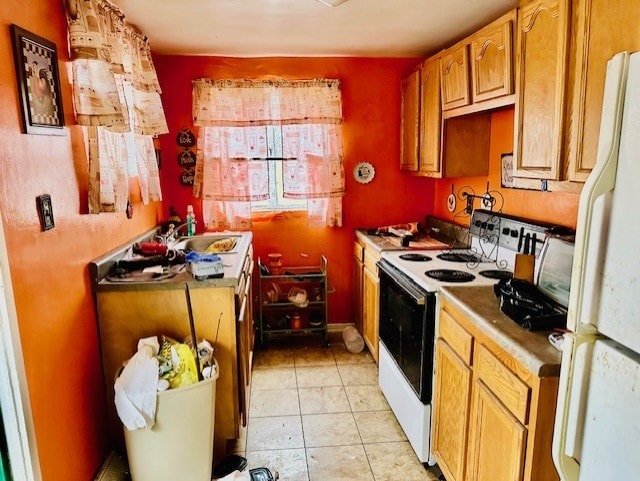 kitchen featuring sink, light tile patterned floors, and white appliances