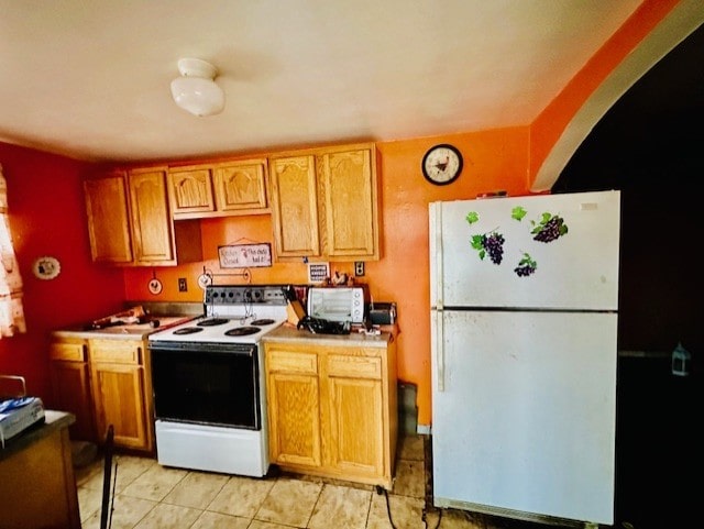 kitchen with light tile patterned floors and white appliances