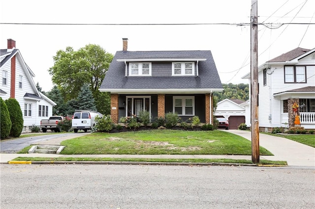 view of front of home with a porch, a garage, and a front lawn